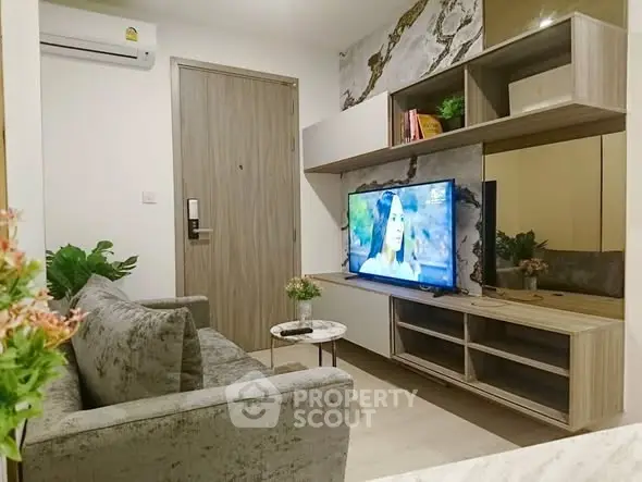 Modern living room with stylish furniture and wall-mounted TV, perfect for cozy relaxation.