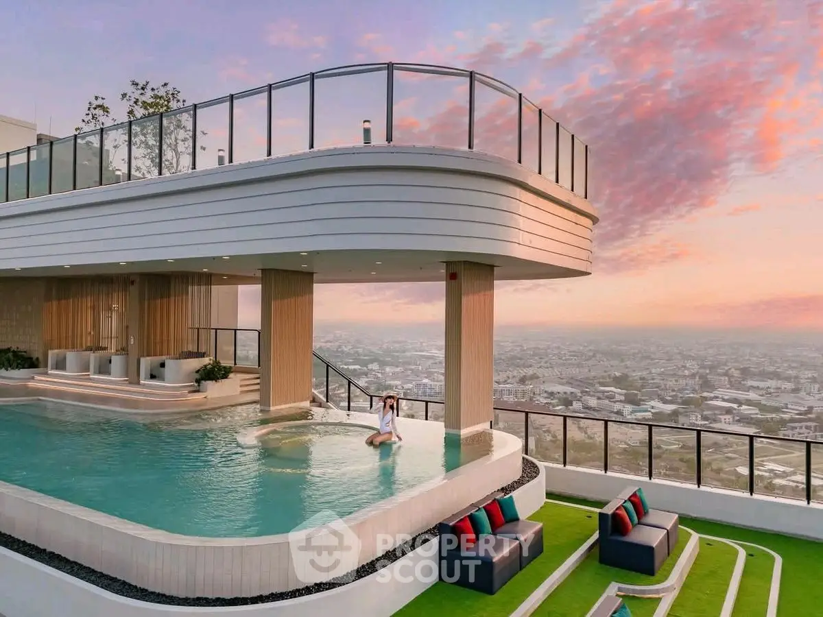 Luxurious rooftop pool with stunning city view and modern seating area at sunset.