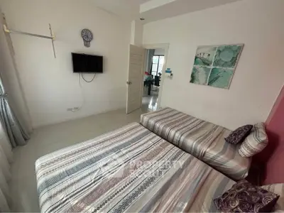 Cozy bedroom with twin beds and modern decor in a stylish home.