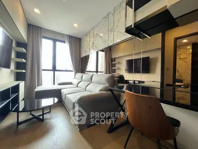 Modern living room with stylish decor and large window for natural light.