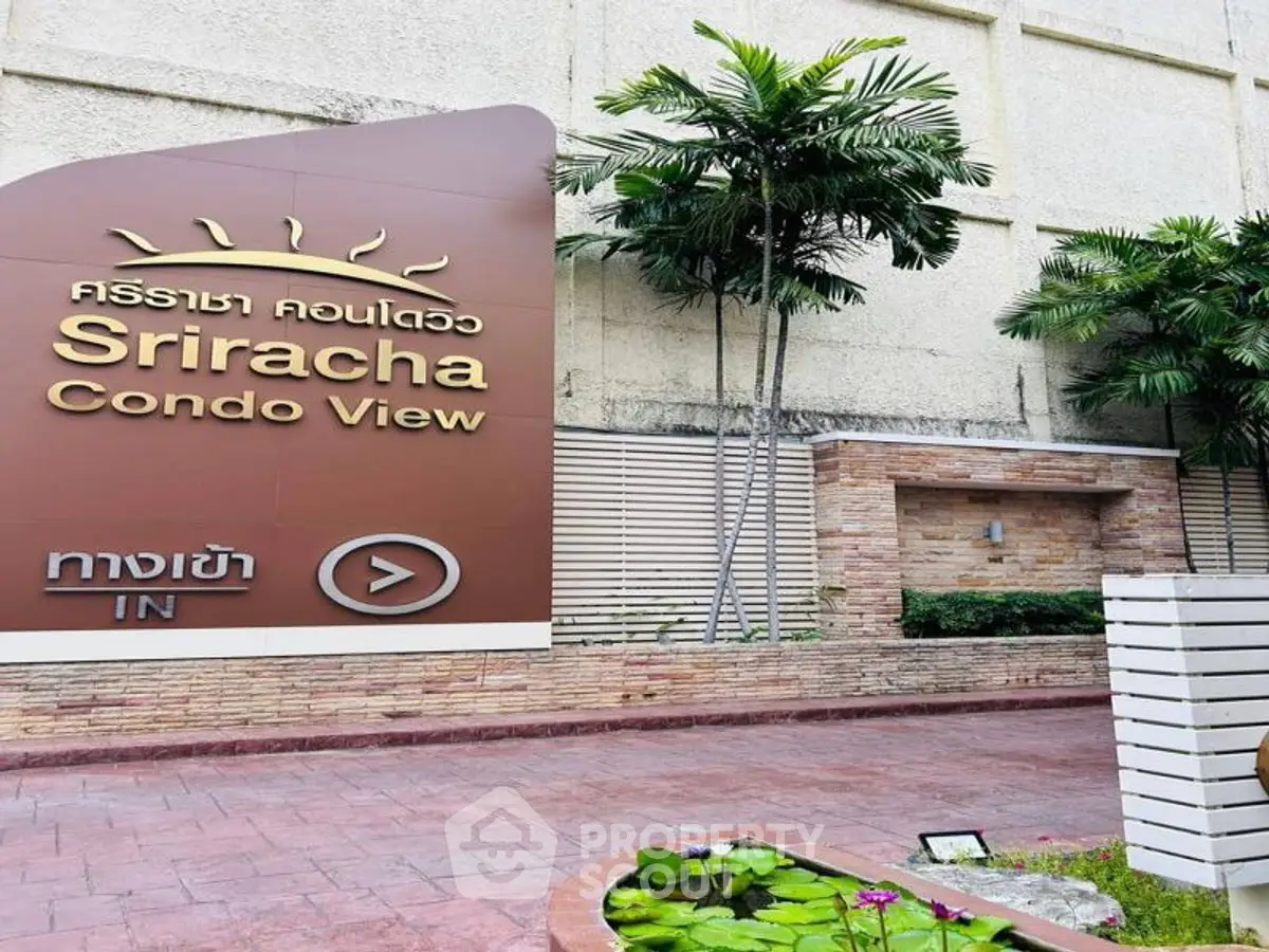 Sriracha Condo View entrance with lush greenery and modern signage.