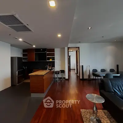 Spacious modern living room with open kitchen and elegant wooden flooring