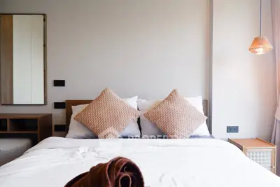 Modern bedroom with stylish decor and cozy lighting, perfect for relaxation.