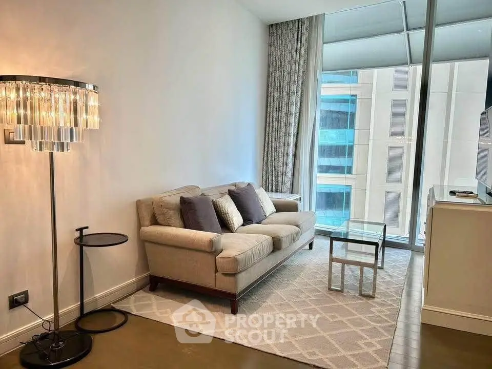 Modern living room with elegant decor and city view from large window.