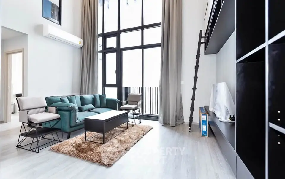 Modern living room with high ceilings, large windows, and stylish furniture in a bright apartment.