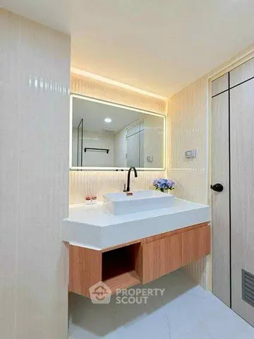 Modern bathroom with sleek vanity and illuminated mirror