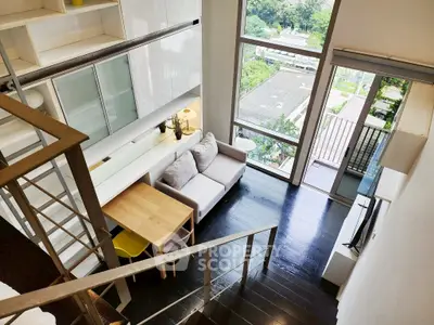 Modern loft apartment with large windows and stylish interior design