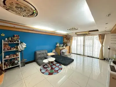 Spacious living room with modern decor and large windows for natural light.