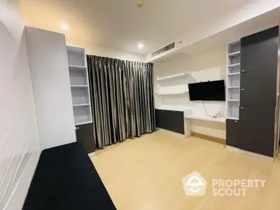 Modern living room with built-in shelves and wall-mounted TV