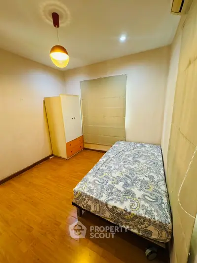 Cozy bedroom with wooden flooring and minimalist decor