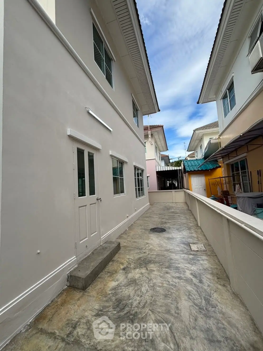 Charming residential exterior with clean facade and spacious walkway in a serene neighborhood.