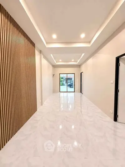 Spacious modern living room with elegant lighting and sleek flooring