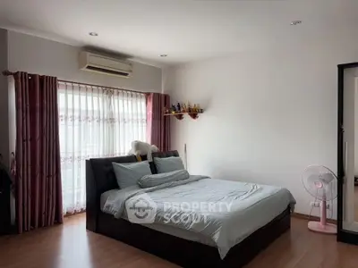 Spacious bedroom with modern decor and natural light