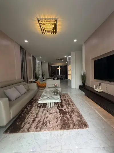 Luxurious modern living room with elegant decor and spacious layout, featuring a plush sofa and stylish lighting.