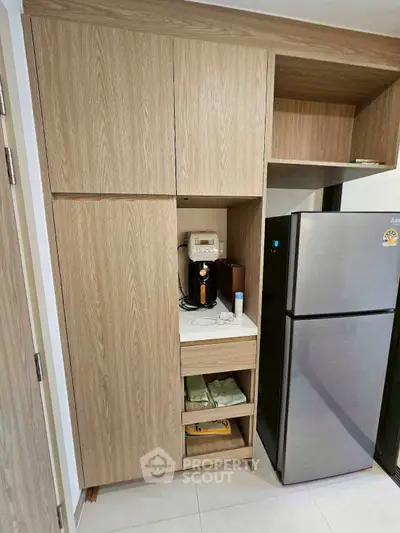Modern kitchen with sleek wooden cabinets and stainless steel fridge