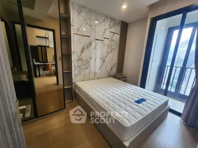 Modern bedroom with marble accent wall and city view balcony in luxury apartment.
