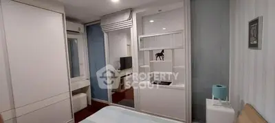 Modern bedroom with sleek design and built-in storage solutions.