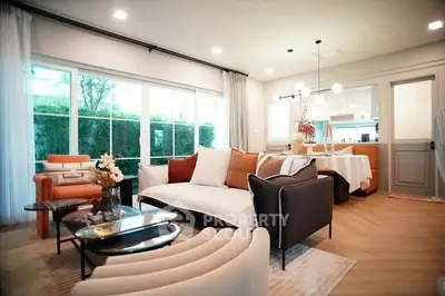 Spacious modern living room with elegant furniture and large windows offering natural light.