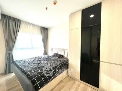 Bright and modern bedroom with large window and stylish wardrobe