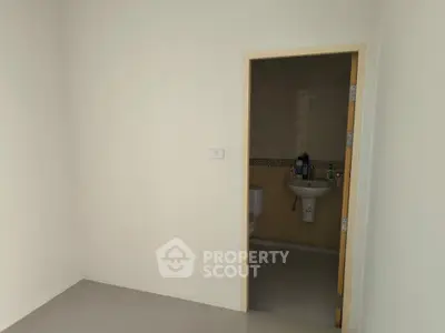 Minimalist interior with bathroom entrance, ideal for modern living spaces.