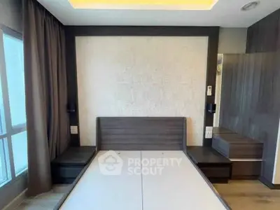 Modern bedroom with sleek design and large window for natural light
