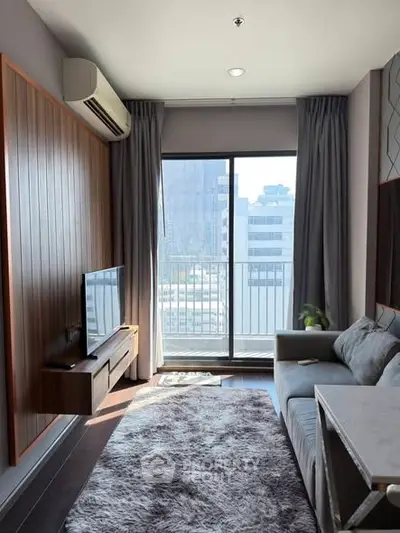 Modern living room with city view, cozy sofa, and stylish decor