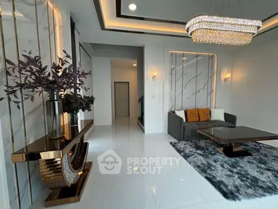 Luxurious living room with modern chandelier and elegant decor