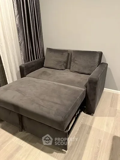 Modern living room with stylish gray sofa and wooden flooring