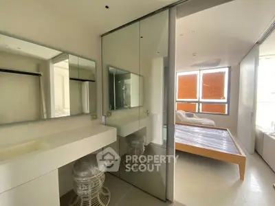 Modern bedroom with mirrored closet and minimalist design