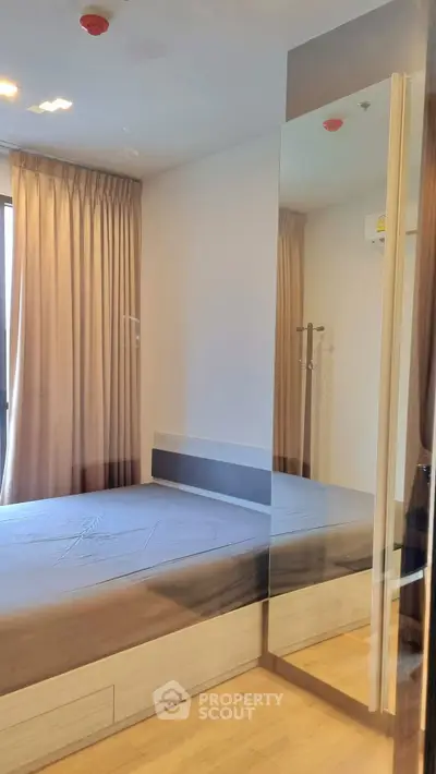 Modern bedroom with large mirror and natural light