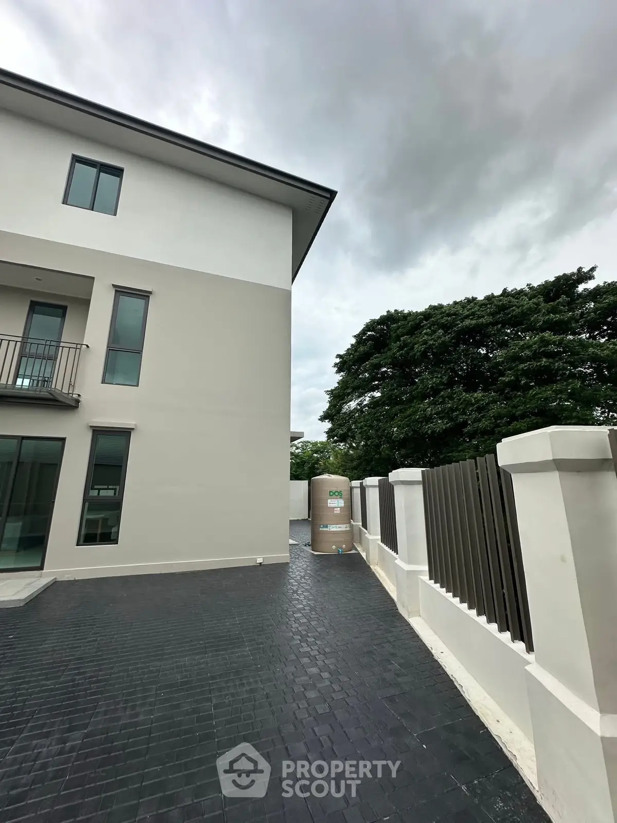 Modern townhouse exterior with sleek design and spacious driveway