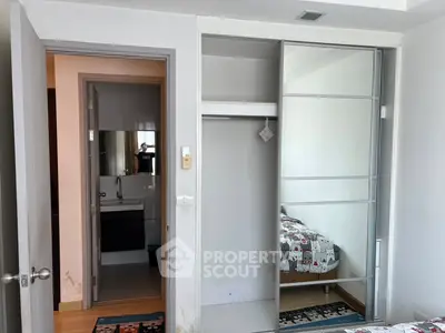 Modern bedroom with sliding closet doors and view into bathroom