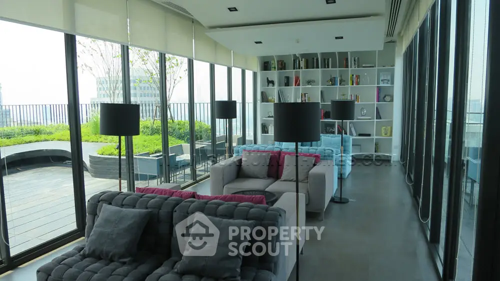 Luxurious modern living room with floor-to-ceiling windows and garden view, featuring stylish sofas and elegant decor.