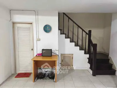 Charming interior with staircase and compact workspace in cozy home setting.