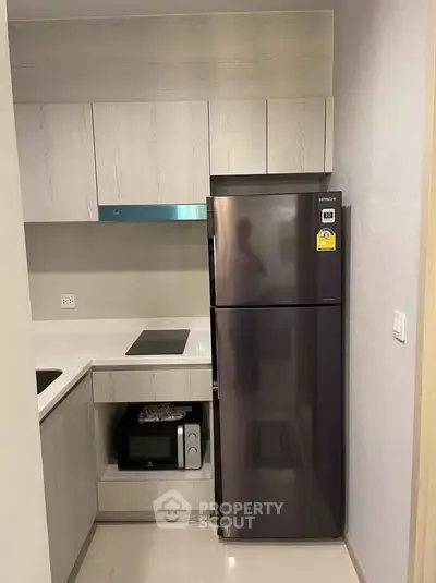 Modern kitchen with sleek appliances and compact design