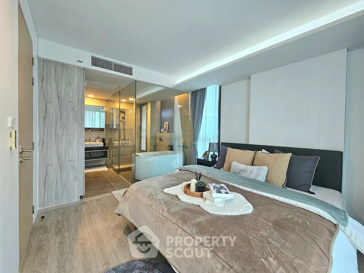 Luxurious bedroom with ensuite bathroom featuring modern design and cozy decor.