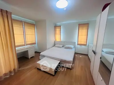 Spacious bedroom with modern furnishings and natural light