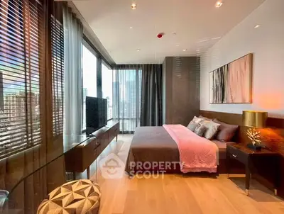 Luxurious modern bedroom with floor-to-ceiling windows and stylish decor in high-rise apartment.
