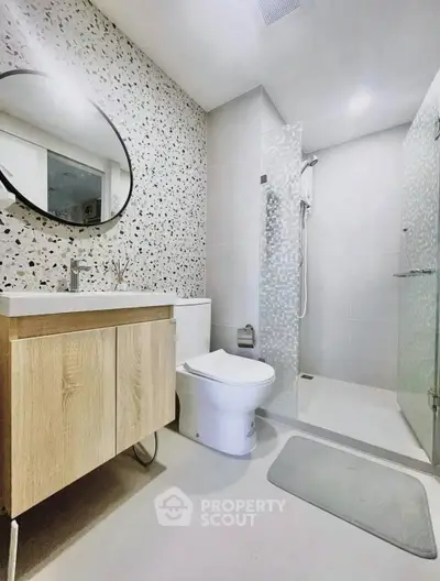 Modern bathroom with stylish terrazzo wall and sleek shower design