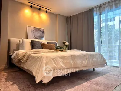 Luxurious bedroom with elegant decor and large window offering natural light and serene views.