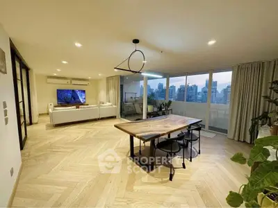 Spacious modern living room with city view and elegant dining area, featuring large windows and stylish lighting.