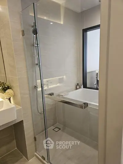 Modern bathroom with glass shower and sleek bathtub design
