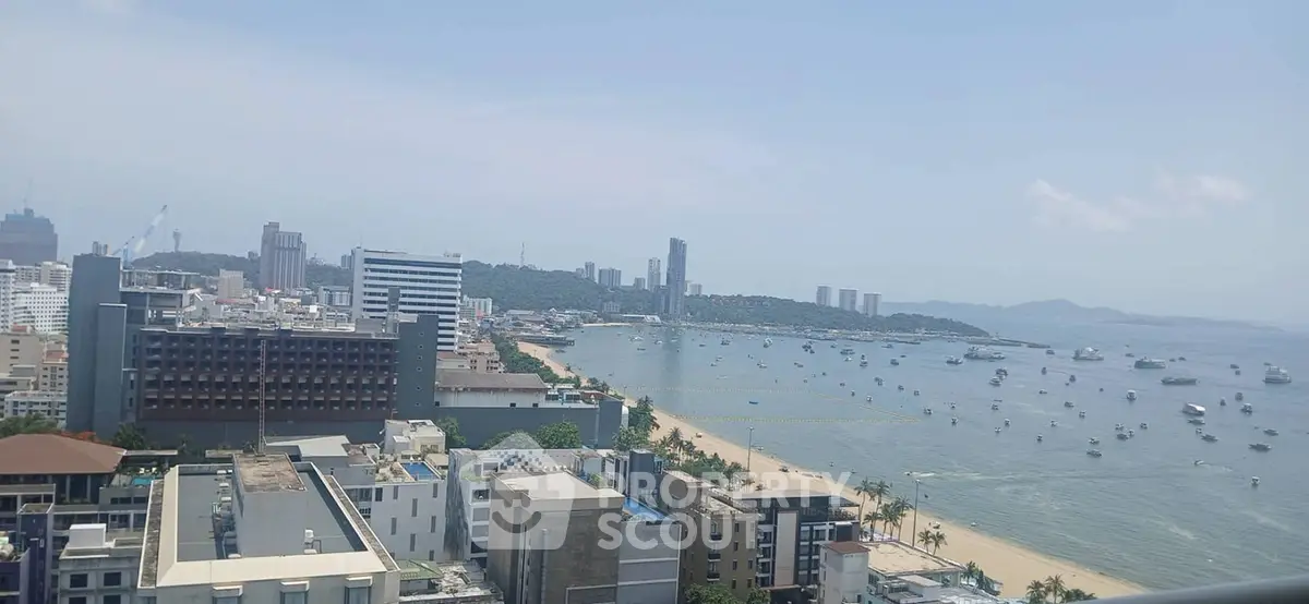 Stunning beachfront cityscape with panoramic ocean views from high-rise balcony.