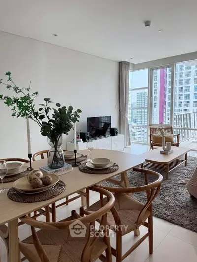 Stylish modern living room with dining area and city view, featuring elegant decor and natural light.