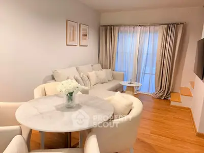 Elegant living room with cozy seating and stylish decor, perfect for relaxation and entertaining.