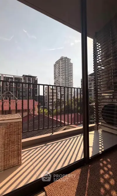 Spacious balcony with city view, perfect for relaxation and enjoying urban living.