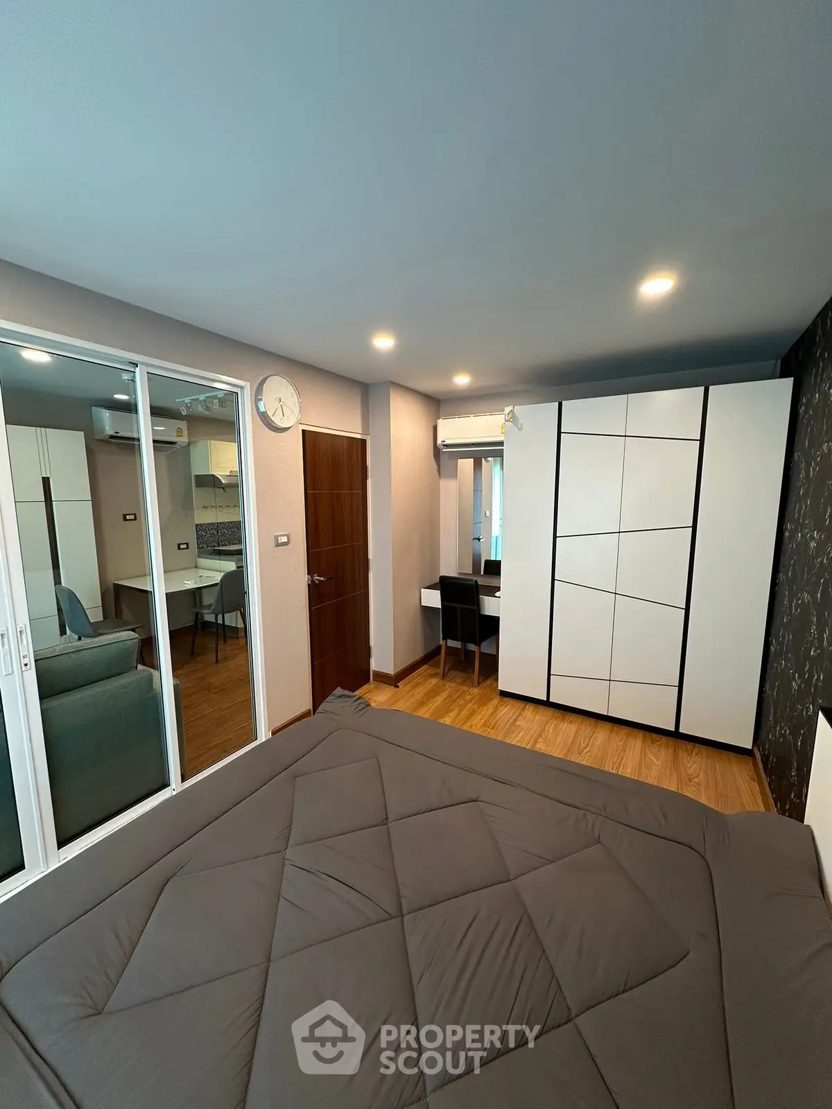 Modern bedroom with sleek design and ample storage in a stylish apartment.