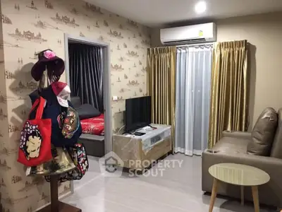 Cozy living room with modern decor and air conditioning, adjacent to a stylish bedroom.
