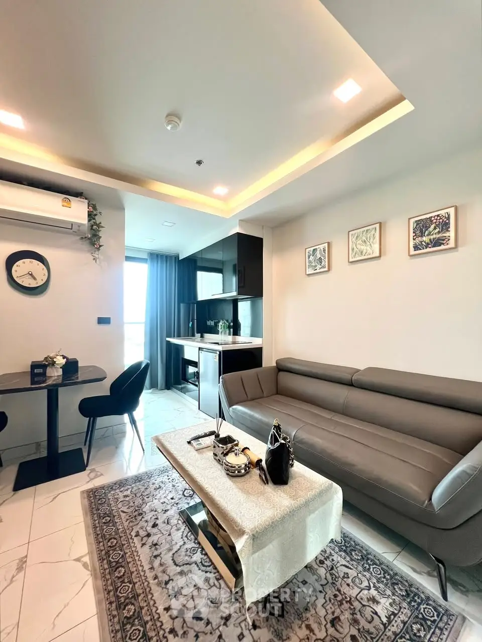 Modern living room with stylish furniture and open kitchen layout