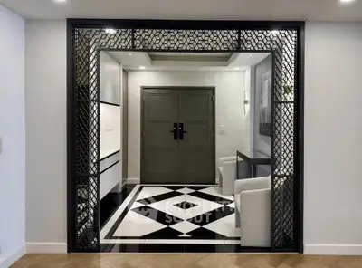 Elegant entrance with geometric floor tiles and stylish seating area
